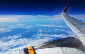 airplane wing above clouds