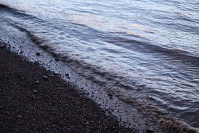 waves on the coast with pebbles