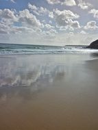 reflection of white clouds in the water of the sea