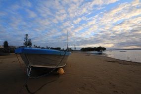 boat in the sunrise light on the sandy beach