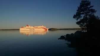 distant view of a cruise liner in the rays of the setting sun