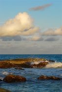 boulders on the ocean against the evening sky