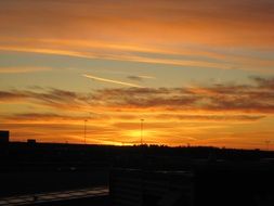 Beautiful golden light in sunset sky above silhouettes