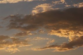 golden illuminated clouds at sunset