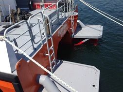 stern of ship with ropes on water