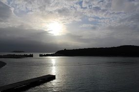 sunshine behind twilight clouds