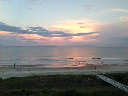 pink sunset in the clouds over the sea and beach