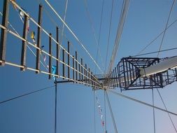 ladder on mast of sailboat at sky, bottom view