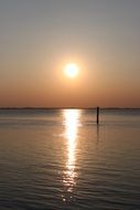 the evening sun is reflected in the lake