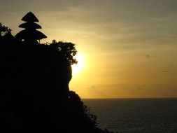 rocky coast of bali at sunset