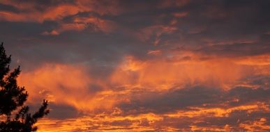 Orange blazing evening sky with clouds