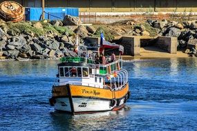 people in boat on water at coast, chile