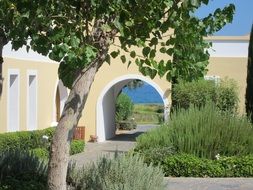 building and yellow arch by the sea in greece