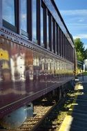 red carriage of passenger train on railway