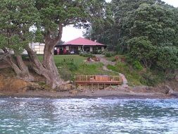 house and gazebo by the water