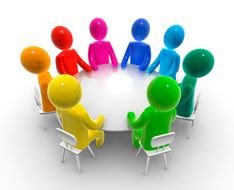 multi-colored little men sit at a round table