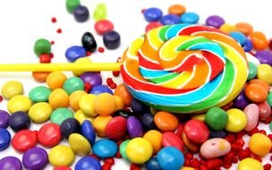multi-colored skittles and candy on a stick