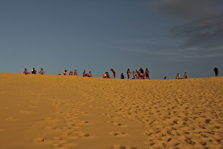 people on the sand dune