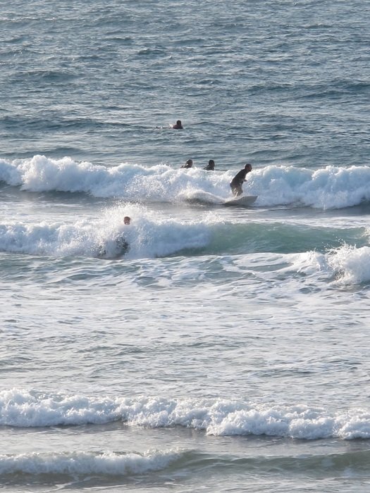 surfers in the white foam of the ocean
