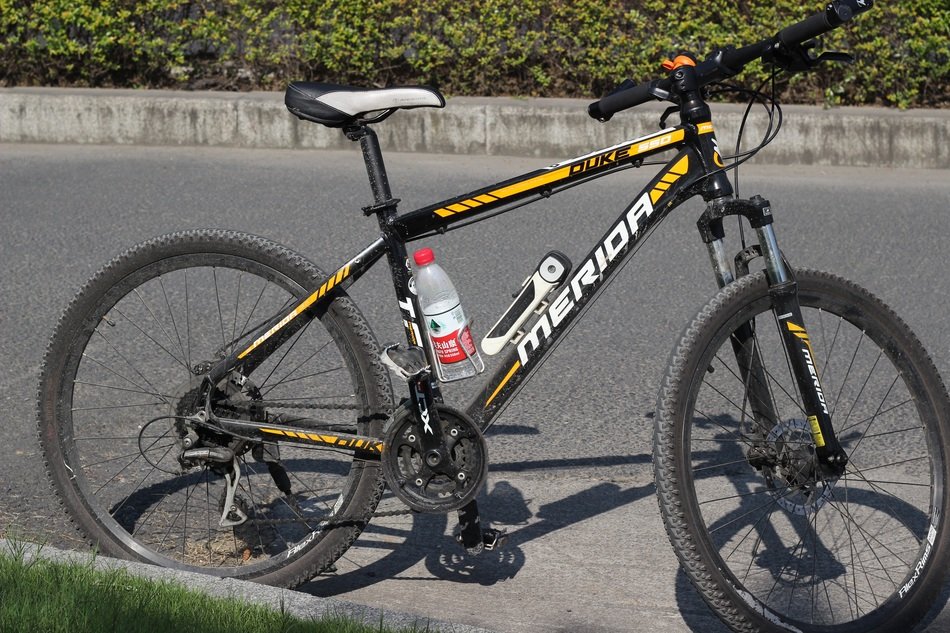 Yellow and black 'Merida' bike on the road