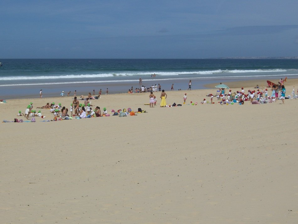 people on the coast of Caparica