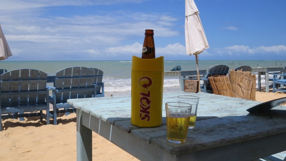 a glass and a bottle of beer are on the table