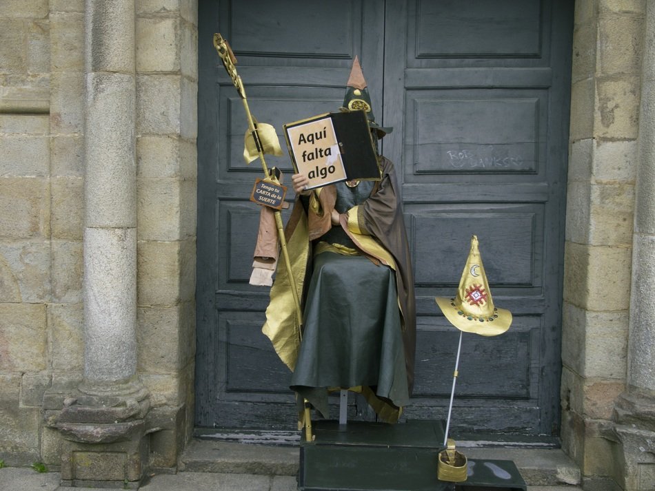 street artist in medieval clothes with book, spain, santiago compostela