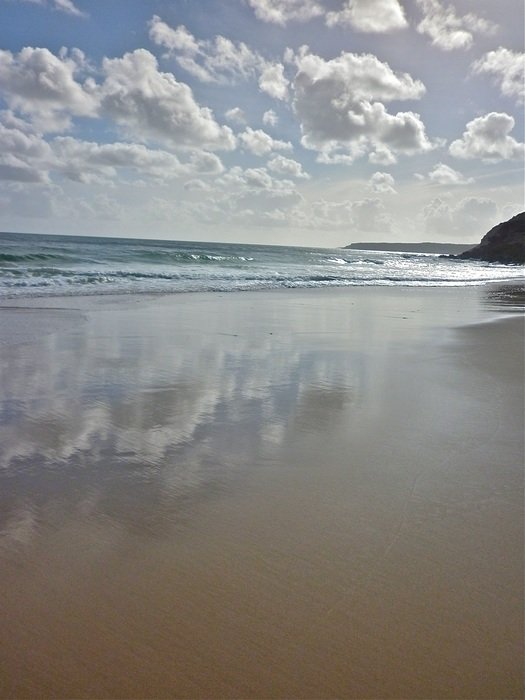 reflection of white clouds in the water of the sea