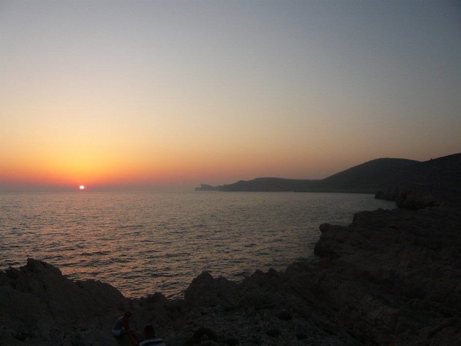 view of the sunset on the horizon of the sea