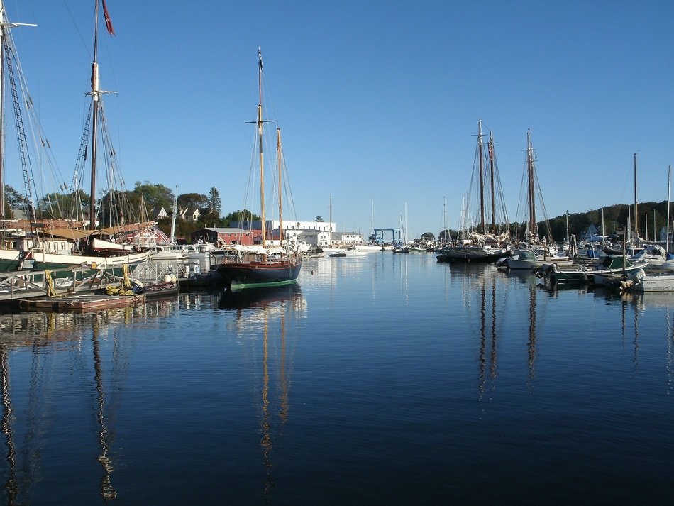 ships with sails in the harbor