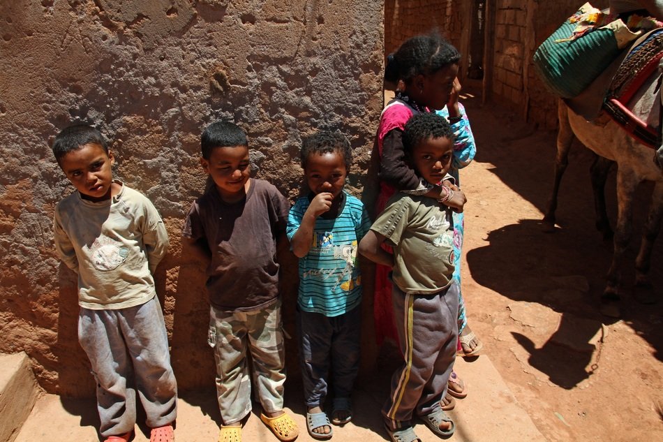 marrakesh children near a stone wall