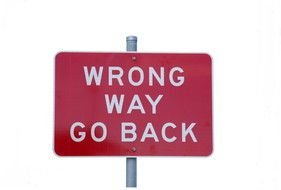 red sign with the inscription on the road