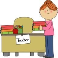 Teacher Putting Books On Desk