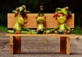 relaxed ceramic frogs on the bench