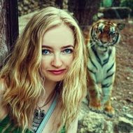 blonde girl against a tiger