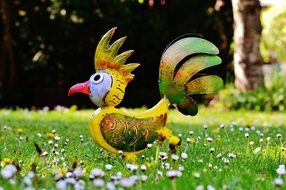 metal bird in the form of a rooster on the grass used for decoration