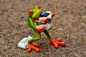 toy frog with papers and calculator