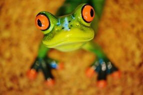 green ceramic frog with red eyes