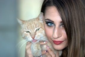 girl is holding a cute cat