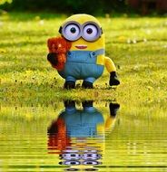 mirror image of minion on the grass in water