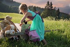 girl playing with toys in the meadow
