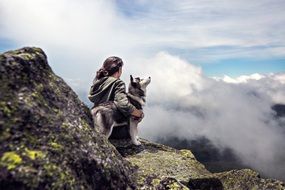 Girl with wolh on Rocks