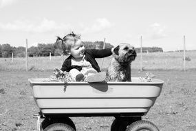 Black and white photo of the toddler and the dog