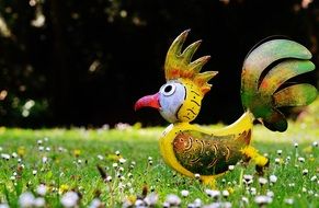 colorful metal bird as a decorative element in the garden