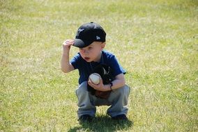 baby with a ball on green grass