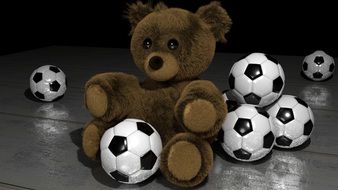 soft brown bear among soccer balls