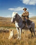 shepherd on horseback with a dog