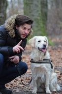 golden retriever with owner in the forest