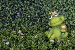ceramic frog figurine on green grass