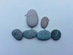 pebble stone illustration of birds on the beach